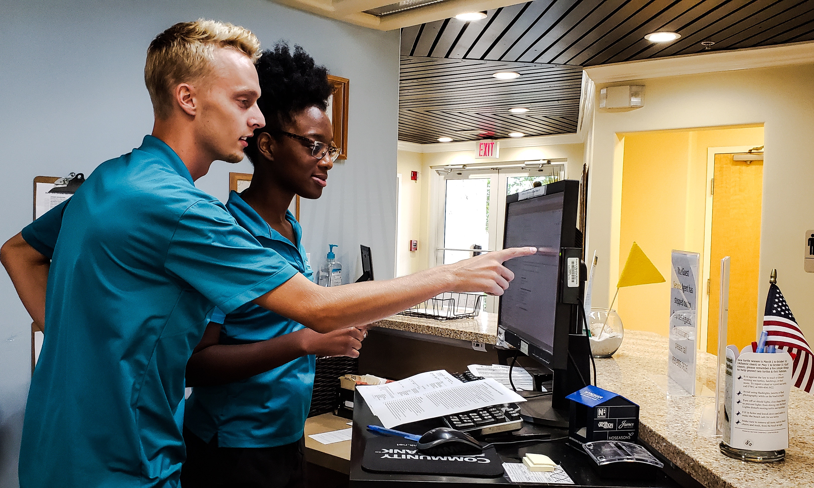 Two interns working at a computer